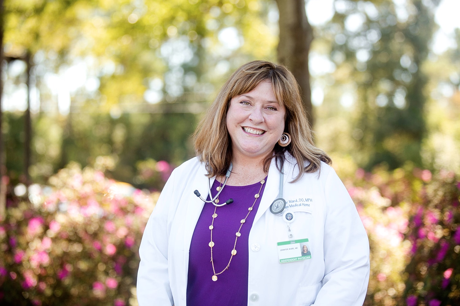 Augusta wellness woman walking on beach with waves.