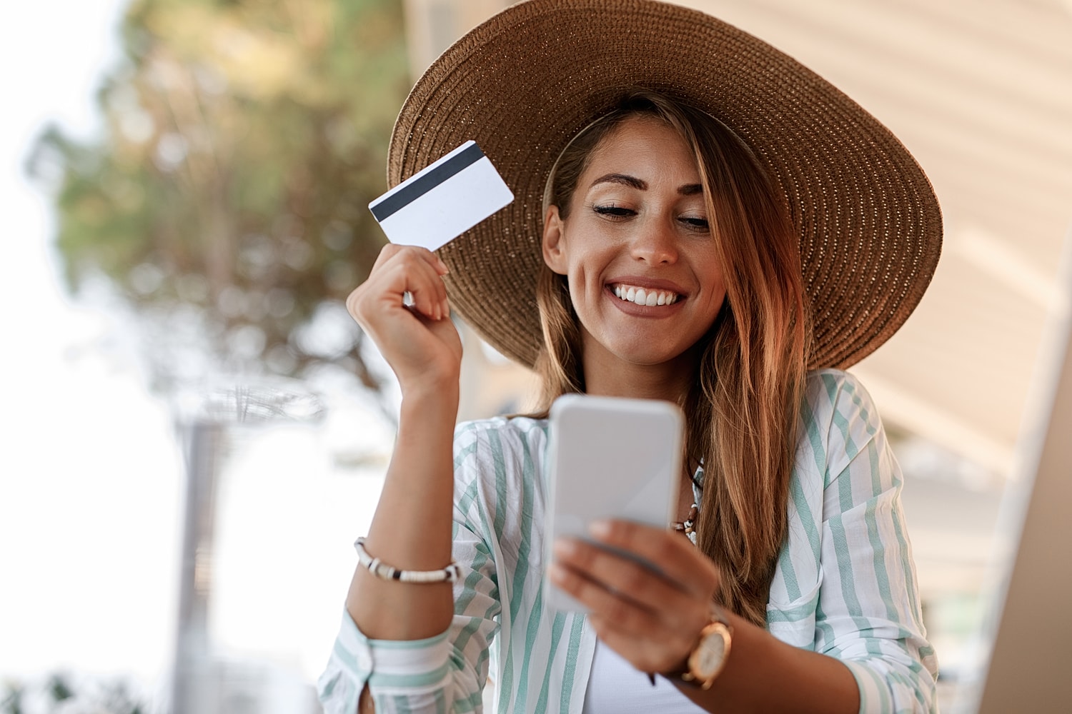 Smiling woman shopping online with a credit card.